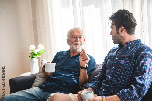 The elderly father and middle-aged son Talking in the house With a coffee cup in hand, Concepts of family and stay at home