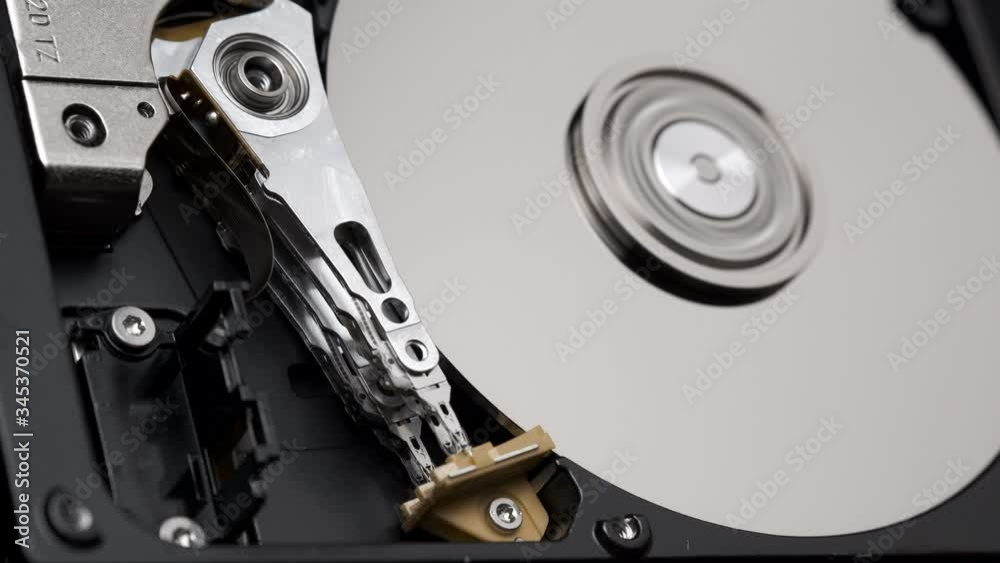 Macro, Close-Up of Actuator Arm of Computer Hard Disk Drive in Work. 4k Macro, Close-Up of Actuator Arm of Computer Hard Disk Drive in Work. 4k