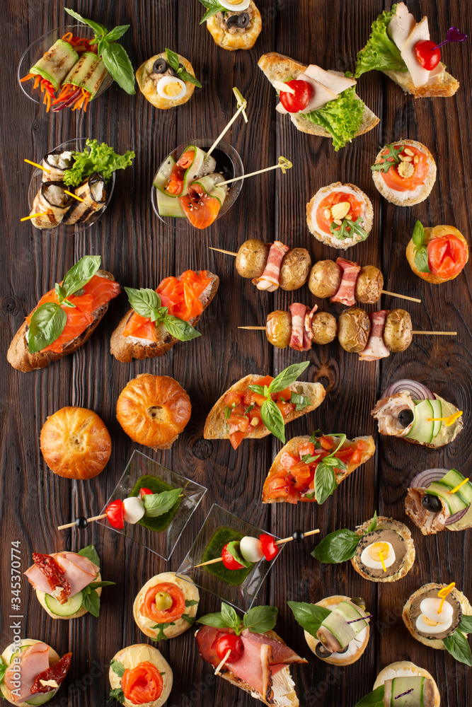 Set of different food snacks and appetizers on wooden background. Beautiful catering banquet buffet table. Set of different food snacks and appetizers on wooden background. Beautiful catering banquet buffet table.
