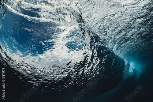 Incredible inside view of the wave. The perfect blue wave for surfing without people. one of the most beautiful waves on the planet. the wave is smooth as a mirror. fisheye photo from the water. photo