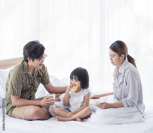 A parents serving breakfast to their little daughter