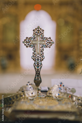 Wedding ceremony closeups in an orthodox church with crowns and wedding rings. 