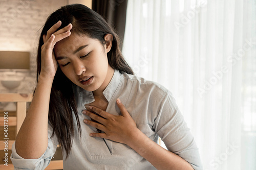 Fotografie Portrait of 20s young Asian woman having difficulty breathing in bedroom at night