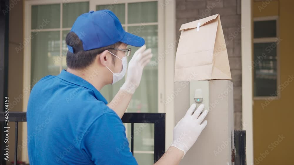 Contactless delivery concept. Delivery asian man or post man pull down food paper bag at front of home with social distance, quarantine to protect form coronavirus. New normal delivery service. Contactless delivery concept. Delivery asian man or post man pull down food paper bag at front of home with social distance, quarantine to protect form coronavirus. New normal delivery service.