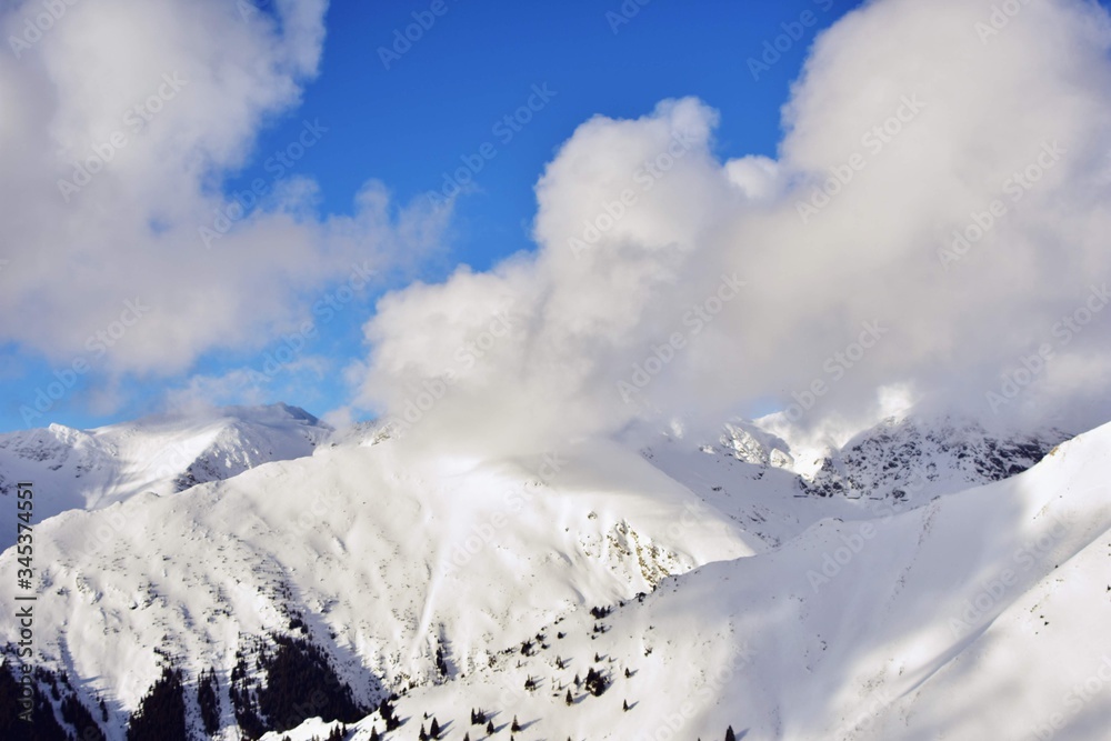 snowy mountains in winter season on sunny day at high altitude