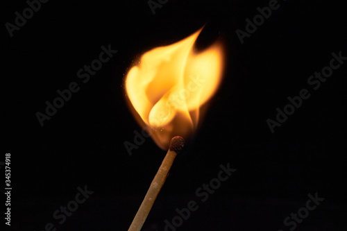 Burning match on a black background