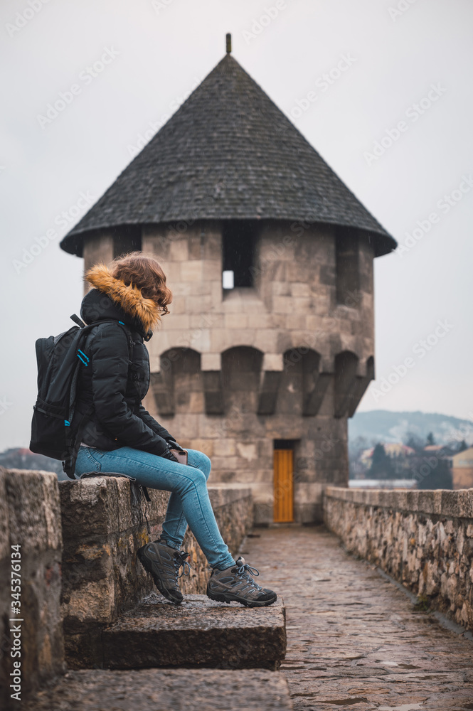 Fototapeta premium Young woman in a medieval castle, woman on vacation in Europe
