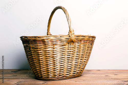 Large wicker basket on a wooden table 