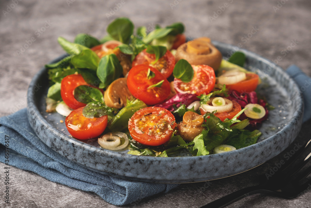 vegetarian salad of leaves, tomatoes, pickled champignon mushrooms, close-up, healthy food vegetarian salad of leaves, tomatoes, pickled champignon mushrooms, close-up, healthy food