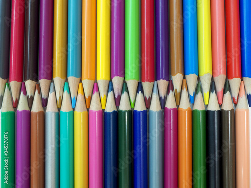 colored pencils lying vertically folded with sharpened edges towards each other in the lock