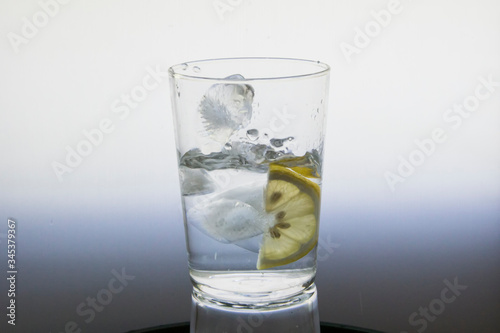 Lemon slice splash effect when falling into a glass with water