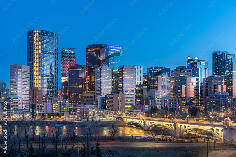 View of Calgary's beautiful skyline at night along the Bow River.  - obrazy, fototapety, plakaty 
