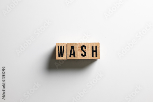 " wash " text made of wooden cube on White background.