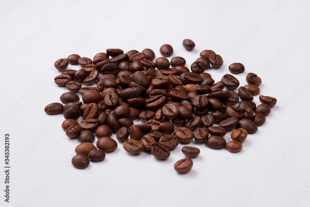Heap of fresh roasted coffee beans. Isolated on white background Heap of fresh roasted coffee beans. Isolated on white background