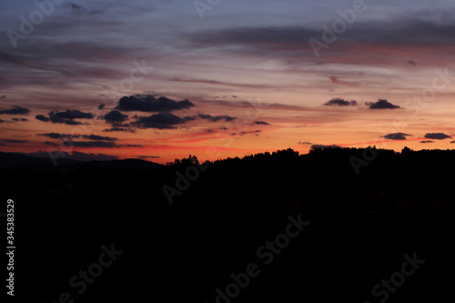 beautiful colored sunset with some clouds in the mountain. Copy space