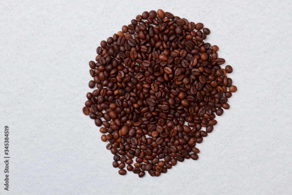 Big pile of roasted coffee beans isolated on white. Top view flat lay. Big pile of roasted coffee beans isolated on white. Top view flat lay.