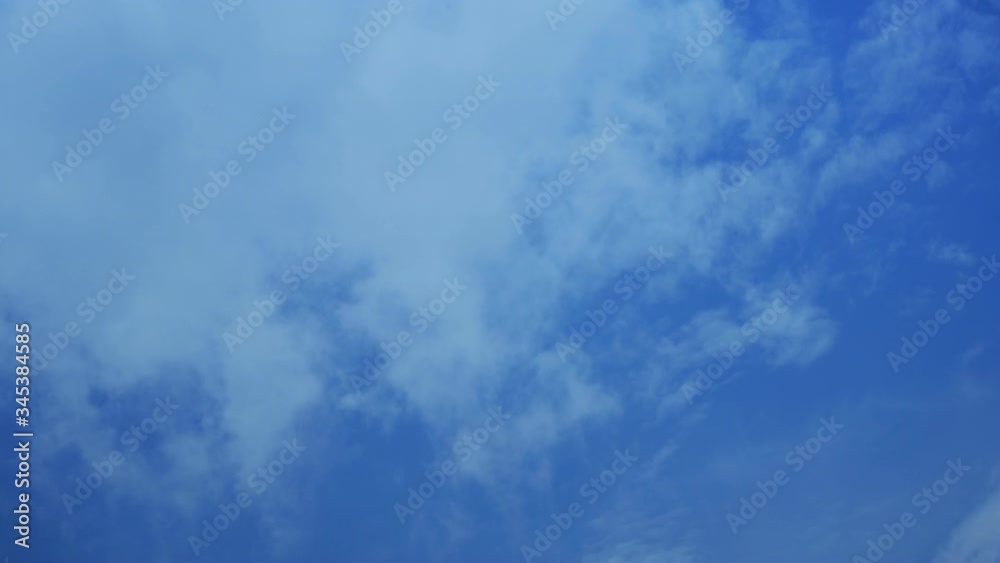 White fluffy clouds on a blue sky background White fluffy clouds on a blue sky background