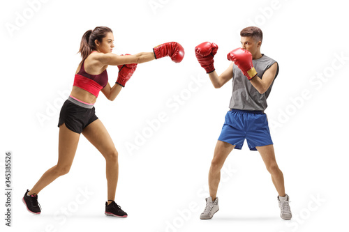 Young guy and woman training boxing