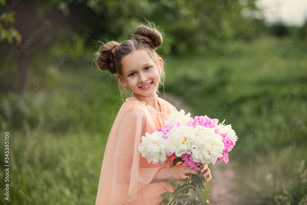 Fototapeta premium young woman in a field. girl with flowerslittle girl sitting on the grass