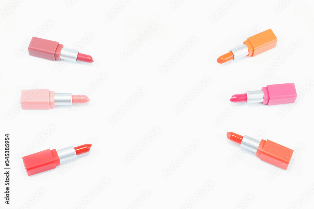 top view of colorful pastel lipstick arranged on white background with copy space