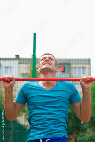 Sport, health and lifestyle concept. Portrait of muscular young man athlete doing push-ups with bars