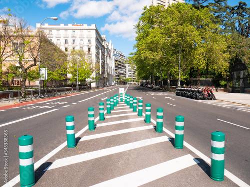 Traffic signs, beacons, greens on O`Donnell Street, next to Retiro Park, completely empty photo