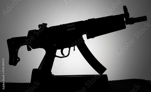The silhouette of a compact assault rifle. photo