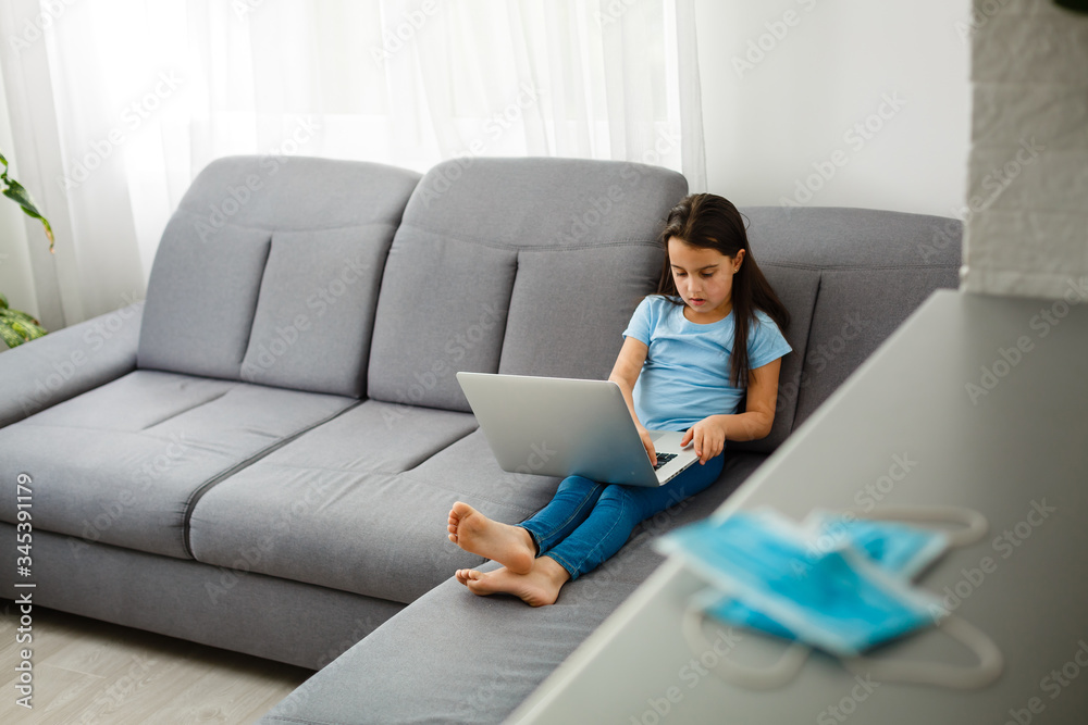 Little Girl Using Digital Laptop E-learning Concept. little girl children using laptop computer, studying through online e-learning system. Little Girl Using Digital Laptop E-learning Concept. little girl children using laptop computer, studying through online e-learning system.