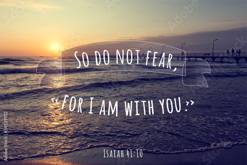Christian encouraging saying from Isaiah 41:10, God is with you. Christian saying on beautiful sunrise over the sea background
