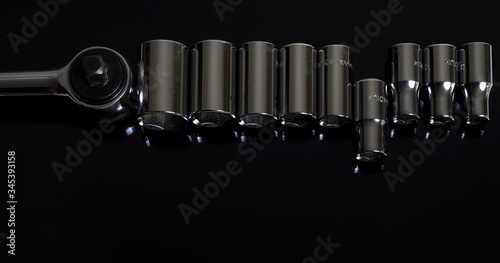 Ratchets and nozzles   on a black background. Professional instrument. Lettering - Chrome Vanadium photo