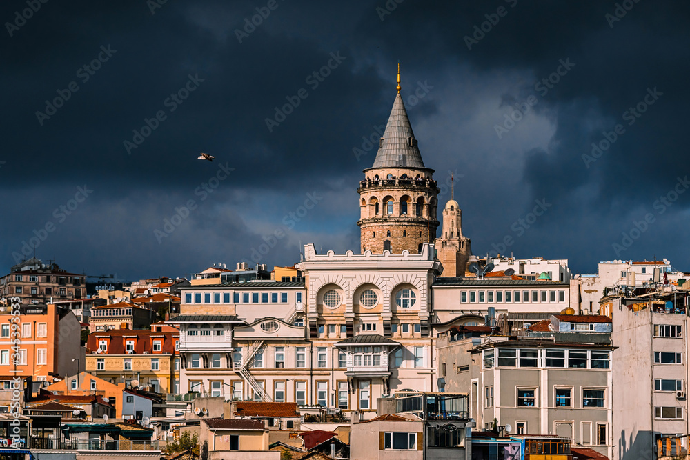 The Galata tower and the old quarters of Istanbul on the background of dark sky. Istanbul before the storm.