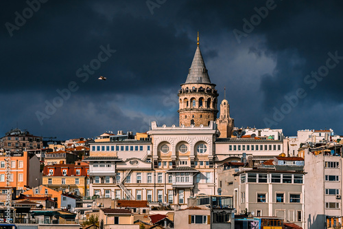 The Galata tower and the old quarters of Istanbul on the background of dark sky. Istanbul before the storm.