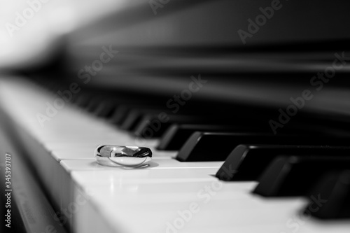 Close-up of piano keyboard with wedding ring
