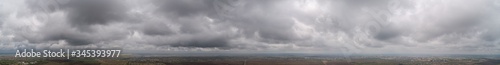 The stormy clouds on sunset panorama