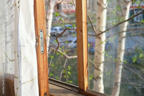 open window of old house. wooden window with spring view. old dirty glass. spring cleaning concept. © Yulia Panova