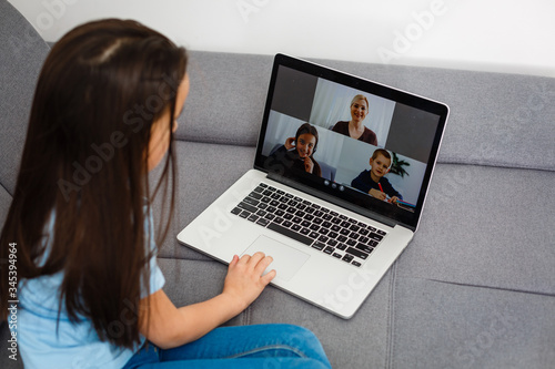 Cute little girl using laptop at home. Education, online study, home studying, distance learning, schoolgirl children lifestyle concept