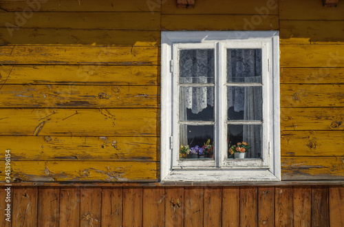 Traditional old white window in a wooden house in Poland