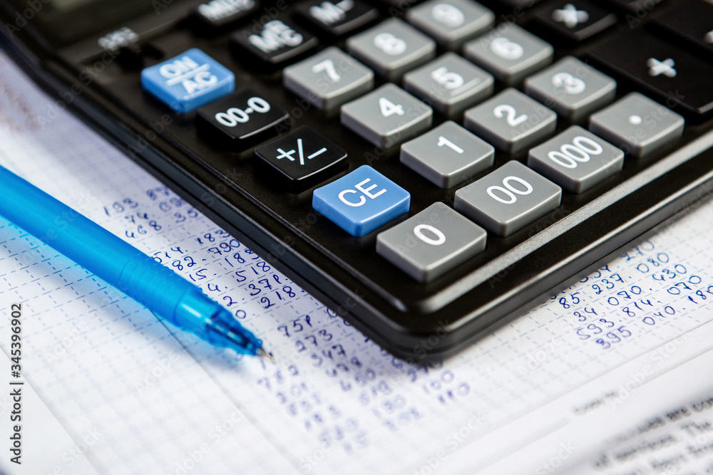 Pen and calculator. Background Items for doing business in the office in the composition.