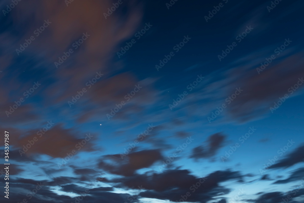 Beautiful long exposure blue evening sky with clouds.  Nature background.