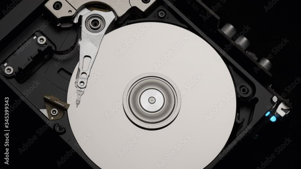 Macro, Close-Up of Computer Hard Disk Drive Spinning and Writing. Blue Lights Blinking. Slow Motion. Macro, Close-Up of Computer Hard Disk Drive Spinning and Writing. Blue Lights Blinking. Slow Motion.