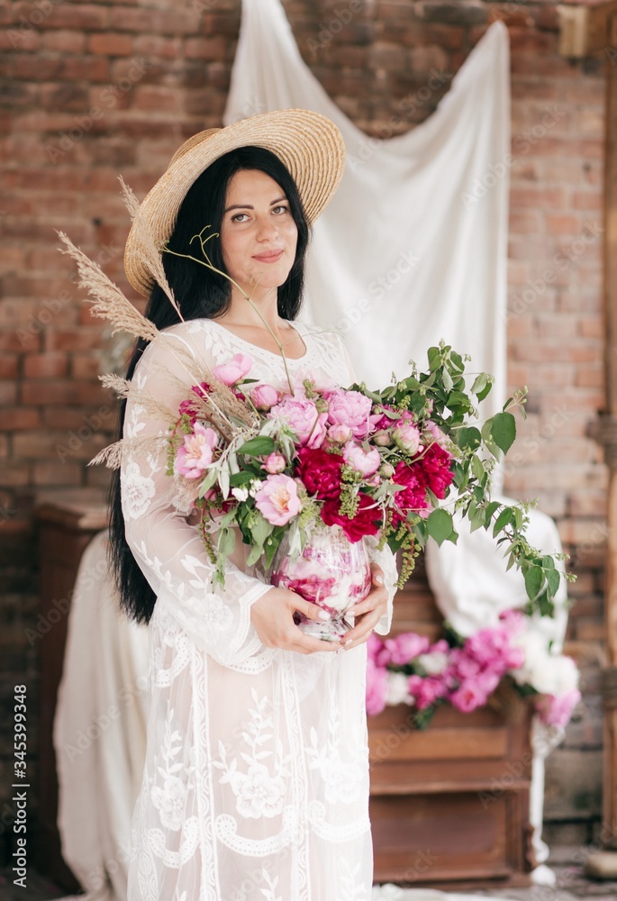 Portrait of beautiful brunette woman in pink dress with pink and white pi-mesons