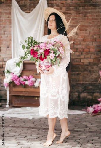 Portrait of beautiful brunette woman in pink dress with pink and white pi-mesons