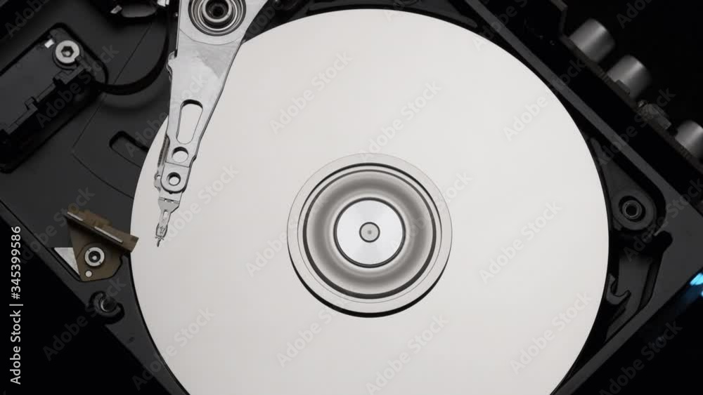 Macro, Close-Up of Computer Hard Disk Drive Spinning and Writing. Blue Lights Blinking. Slow Motion. Macro, Close-Up of Computer Hard Disk Drive Spinning and Writing. Blue Lights Blinking. Slow Motion.