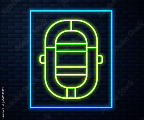 Glowing neon line Rafting boat icon isolated on brick wall background. Inflatable boat. Water sports, extreme sports, holiday, vacation.  Vector Illustration