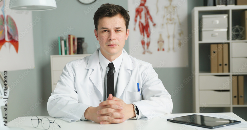 Portrait of young doctor sitting in medical office