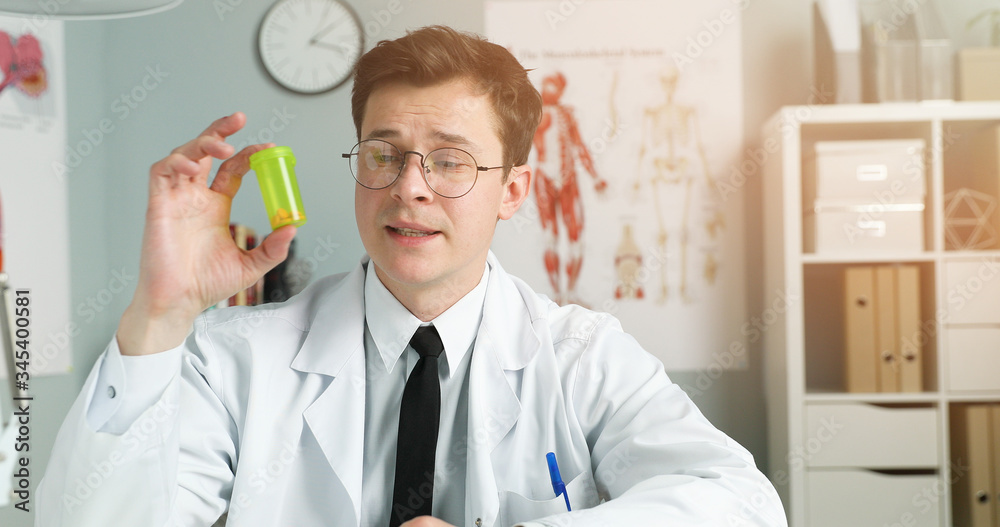Portrait of young doctor sitting in medical office Portrait of young doctor sitting in medical office