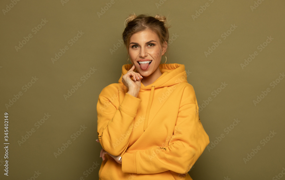 Portrait of a pretty smiling woman posing isolated on a color background.