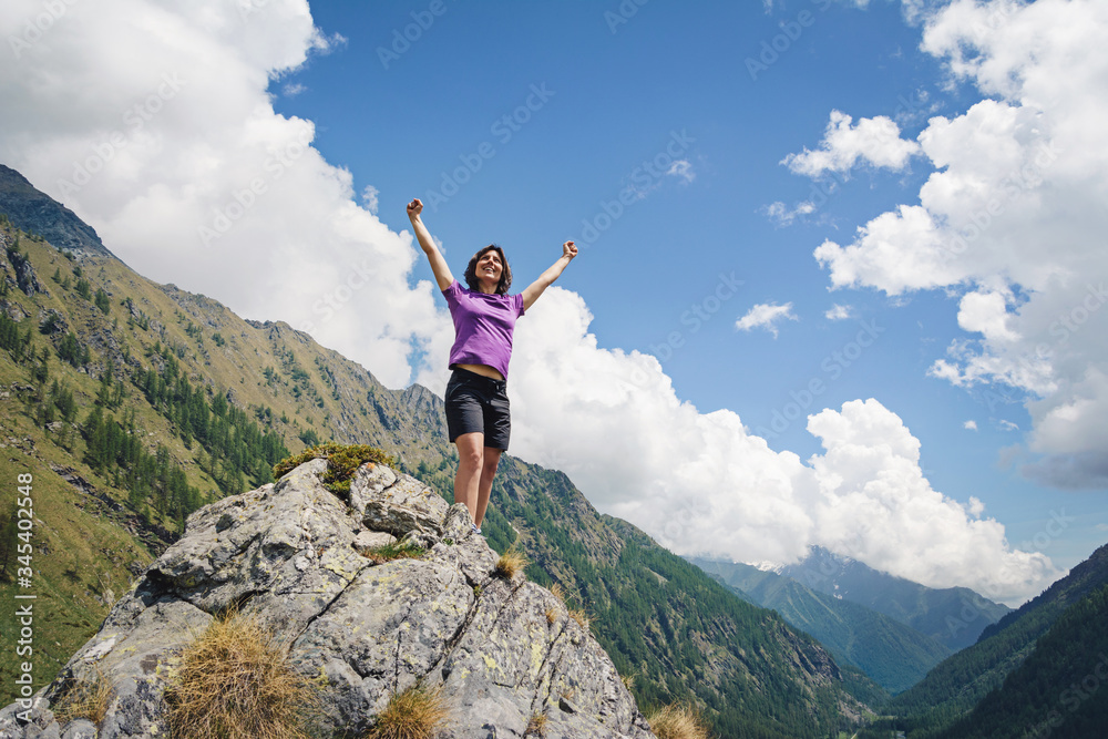 woman standing on the top of mountain in italian Alps. Gran Paradiso National Park. Italy
