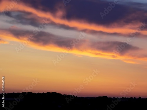 Clouds highlighted by the morning sun  visible from industrial heap before the dawn