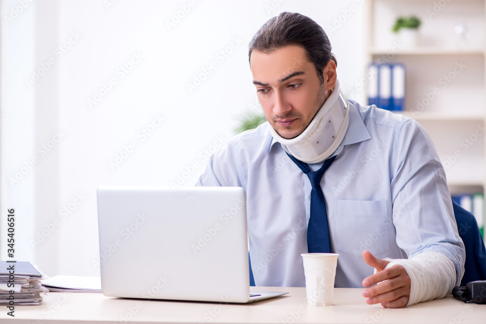 Injured male employee at workplace after accident Injured male employee at workplace after accident